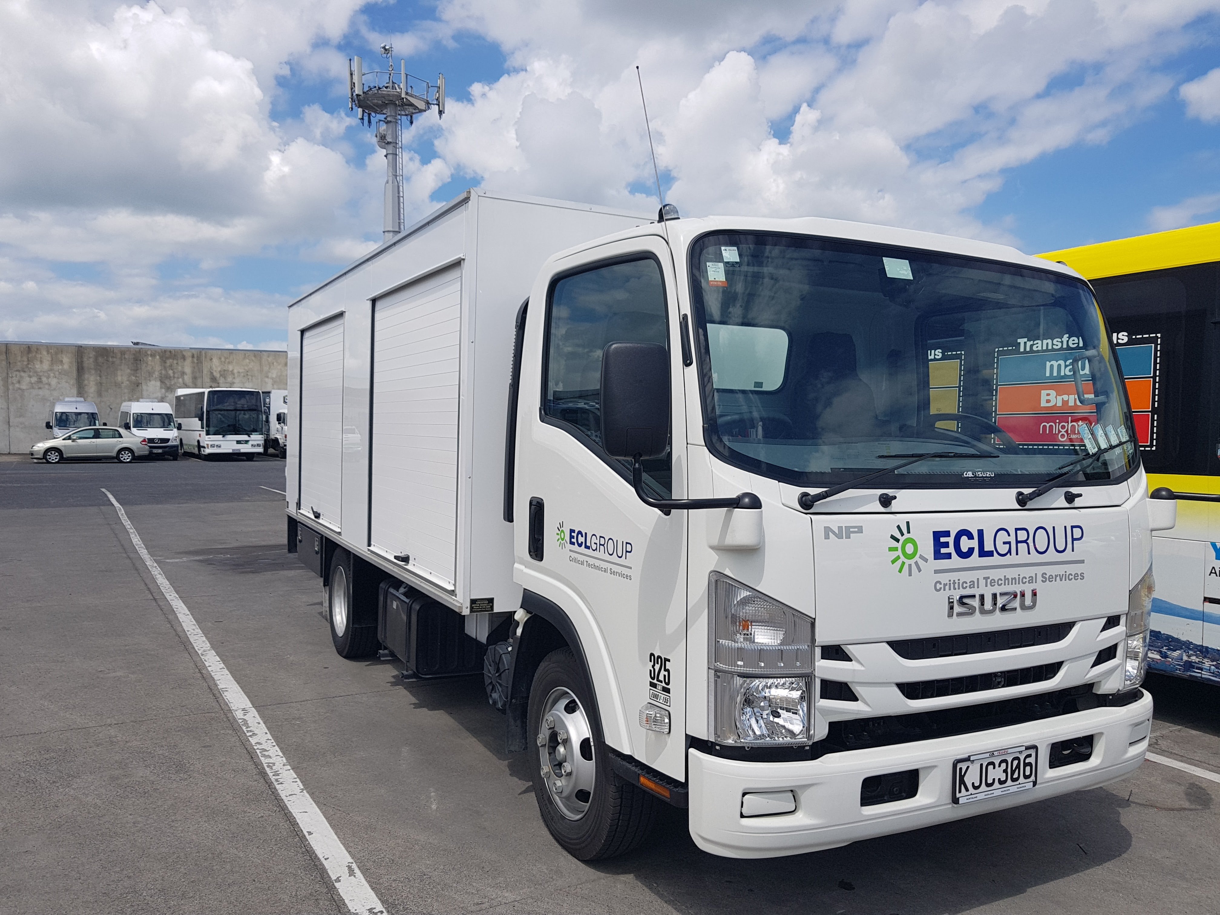 A white delivery truck parked in a car park