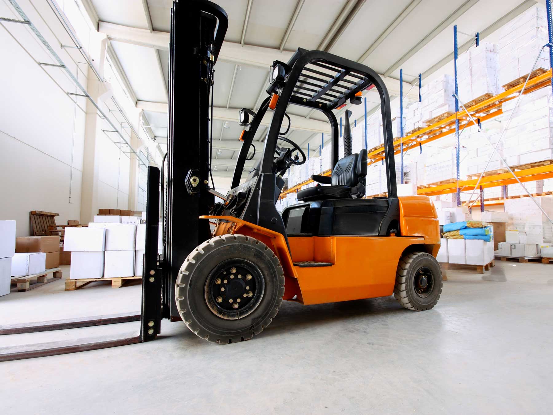 orange forklift in operation in a warehouse